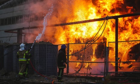 Firefighters at work after a Russian attack targeting energy infrastructure in Kyiv in October 2022