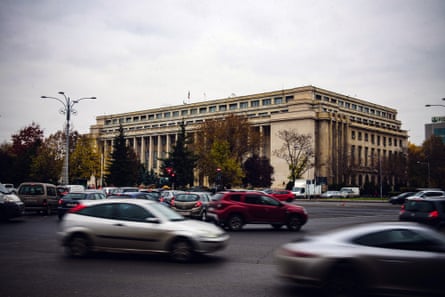 the traffic looks busy and quite chaotic. Vehicles including an SUV, a sports coupe, vans and small hatchbacks can be seen.