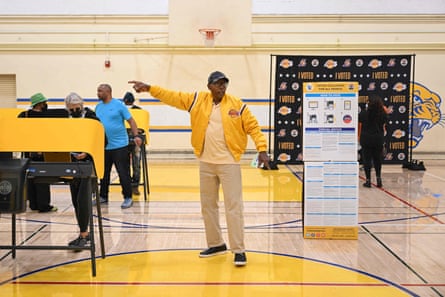 An election worker directs people to voting machines during the US midterm elections in Los Angeles, California.