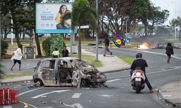 Scene of rioting with a burnt-out car