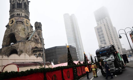 Emergency service personnel stand near the truck that crashed into the Christmas market near the Kaiser Wilhelm memorial church in Berlin