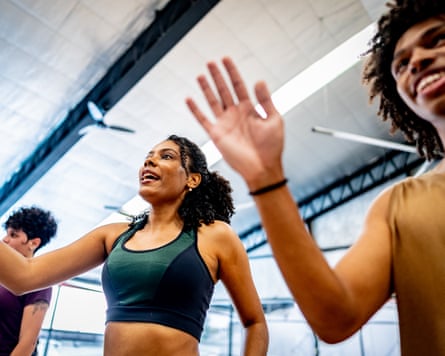 A group of people in a fitness class in a gym