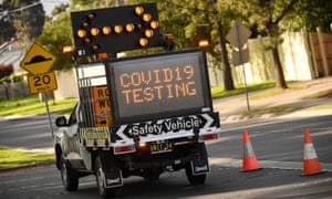 A sign points toward the entrance of a coronavirus disease (COVID-19) drive-through testing facility in Melbourne, Australia, August 18, 2020.