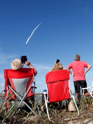 Spectators at Cocoa Beach near Cape Canaveral watch the rocket launch.