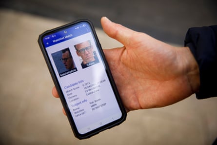 Robert Booth’s face and record shown on an officer’s handheld
