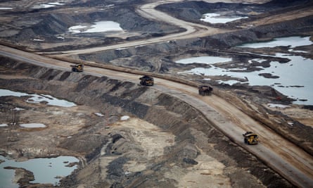 Trucks carry raw tar sands near Fort McMurray, Canada.