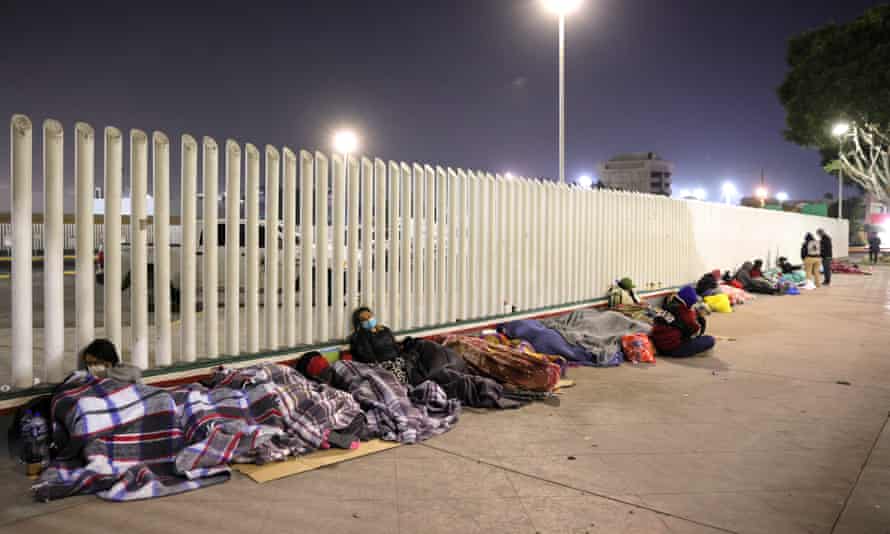 Asylum seekers try to sleep and rest at the Tijuana border.