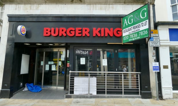 A person sleeping rough in the doorway of a shuttered Burger King outlet in Oxford