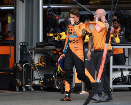 McLaren driver Oscar Piastri walks back to the pit lane after crashing during the qualifying