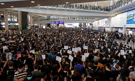 Anti-extradition bill protesters attend a mass demonstration after a woman was shot in the eye during a protest at Hong Kong International airport