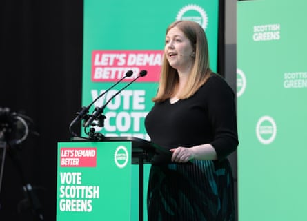 Mackay, wearing a black dress, speaks at the manifesto launch event