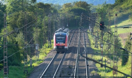 Train on electric track in Germany through trees