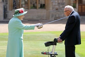 Queen Elizabeth II awards Captain Sir Thomas Moore with the insignia of Knight Bachelor at Windsor Castle in July.