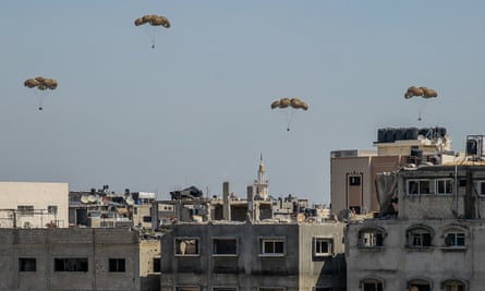 Humanitarian aid parcels attached to parachutes being airdropped into Gaza
