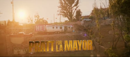 A man stands at the side of an Airstream trailer in a lot with the words ‘Pratt for LA Mayor’ superimposed.
