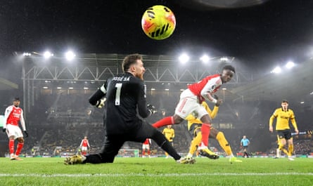 Bukayo Saka of Arsenal heads the ball past Wolves keeper Jose Sa to open the scoring.