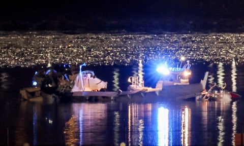 This image appears to show some wreckage from the plane in the Potomac River alongside rescue workers.