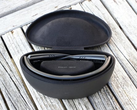 The Oakley Meta Vanguard pictured folded in their charging case with the lid open.
