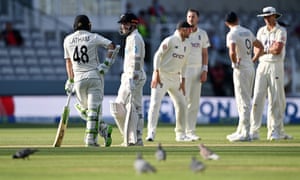 Kane Williamson of New Zealand speaks to Tom Latham as he waits for his review to be overturned.