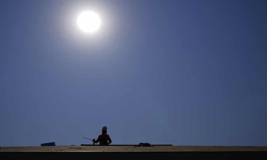 A roofer works under the baking sun on 17 June in Phoenix. 