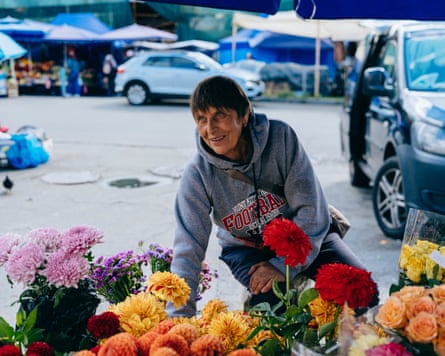 Halyna is selling flowers next to the burnt market in Lukyanivka district of Kyiv