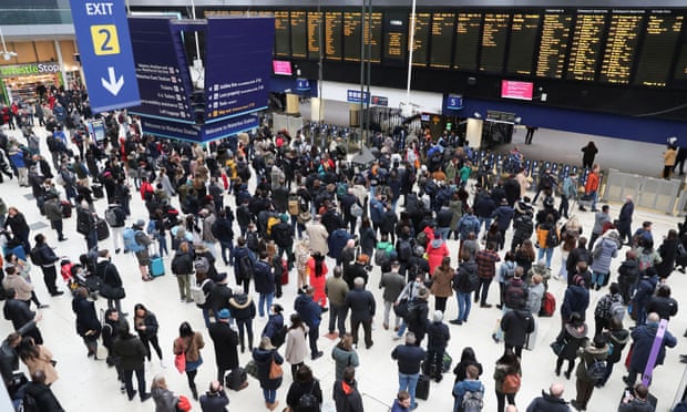 People wait at London’s Waterloo station