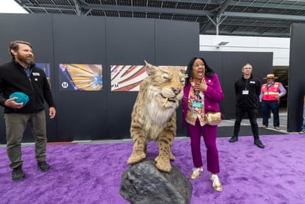 a female adjacent a tiger statue
