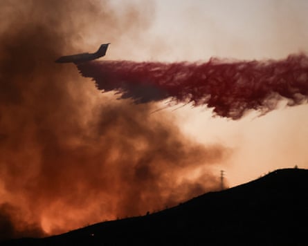 A firefighting aircraft drops fire retardant in California.