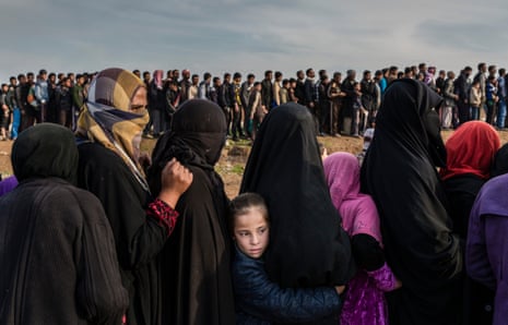 Civilians who had remained in west Mosul during the battle to retake the city lining up for an aid distribution in the Mamun neighbourhood, Iraq, March 2017.
