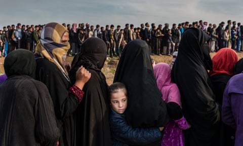 Civilians who had remained in west Mosul during the battle to retake the city, lining up to receive aid, Iraq 2017.
