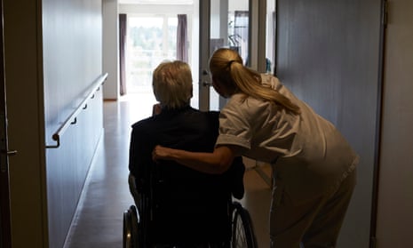 A health care worker with an aged person in a care home