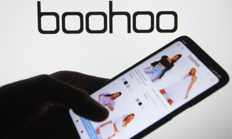 Boohoo website on a mobile phone with the Boohoo logo in the background.
