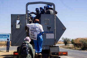 Zimbabwean novelist Tsitsi Dangarembga (centre) and a colleague, Julie Barnes, being are arrested during an anti-corruption protest march in Harare, 31 July 2020.