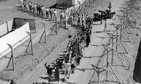 Suspected Mau Mau militants opposed to the British rule of Kenya are marched into a detention camp in 1954.