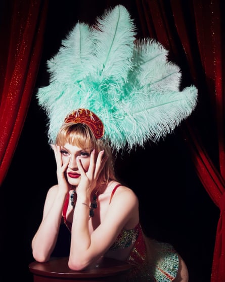 a drag performer in a feather headband