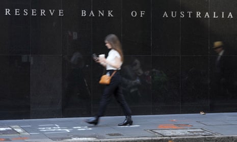  People walk past the outside of the Reserve Bank in Sydney, Australia
