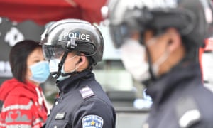 Police officers in Chengdu, China, wearing smart helmets fitted with infrared cameras to detect citizens with high body temperatures.