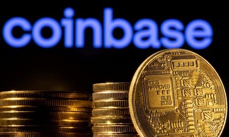 A representation of the cryptocurrency is seen in front of Coinbase logo
