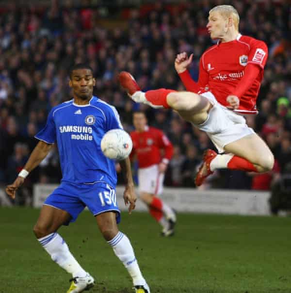 Bobby Hassell competes for possession with Chelsea’s Florent Malouda.