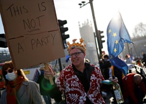 London, UK. Protestors hold placards near the House of Commons, as the Prime Minister answers questions inside about attending a party during lockdown