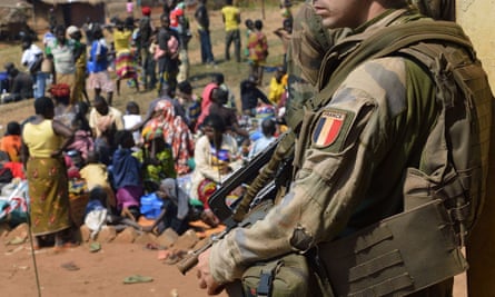 A French soldier guards refugees in Central African Republic in 2014. French prosecutors have opened an investigation into claims that French peacekeepers sexually abused children in during their mission in CAR.