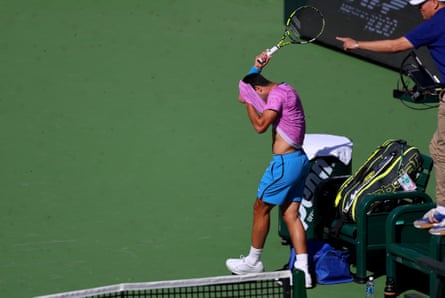 Carlos Alcaraz of Spain gets attacked by a swarm of bees during the BNP Paribas Open.