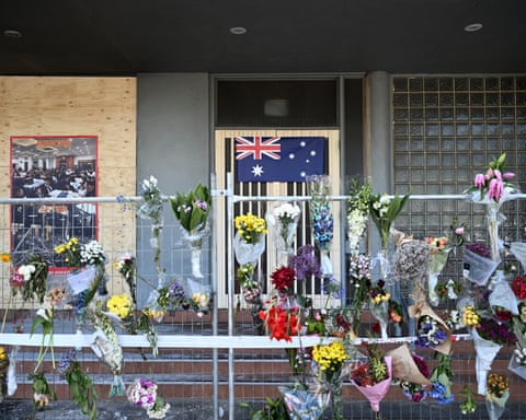 Floral tributes and an Australian flag at the Adass Israel synagogue in Melbourne after it was firebombed in December 2024.