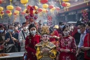 Actor Lana Wong, wearing an ox costume, prays in Wong Tai Sin temple, Hong Kong