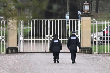 police officers approach a gated entrance