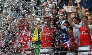 Per Mertesacker and Laurent Koscielny of Arsenal lift The FA Cup.