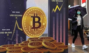 An advertisement for Bitcoin cryptocurrency is displayed on a street in Hong Kong.