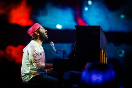 Arijit Singh onstage at an upright piano