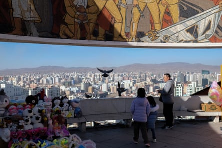 People at a war memorial on a hill overlooking Ulaanbaatar, Mongolia.
