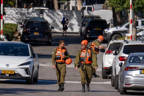 Israeli Home Front Command officers walk near where Israel's government says a drone was launched toward Israeli prime minister Benjamin Netanyahu's house in Caesarea, Israel, on Saturday.